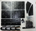 Collection of black metal brackets and components on a white background