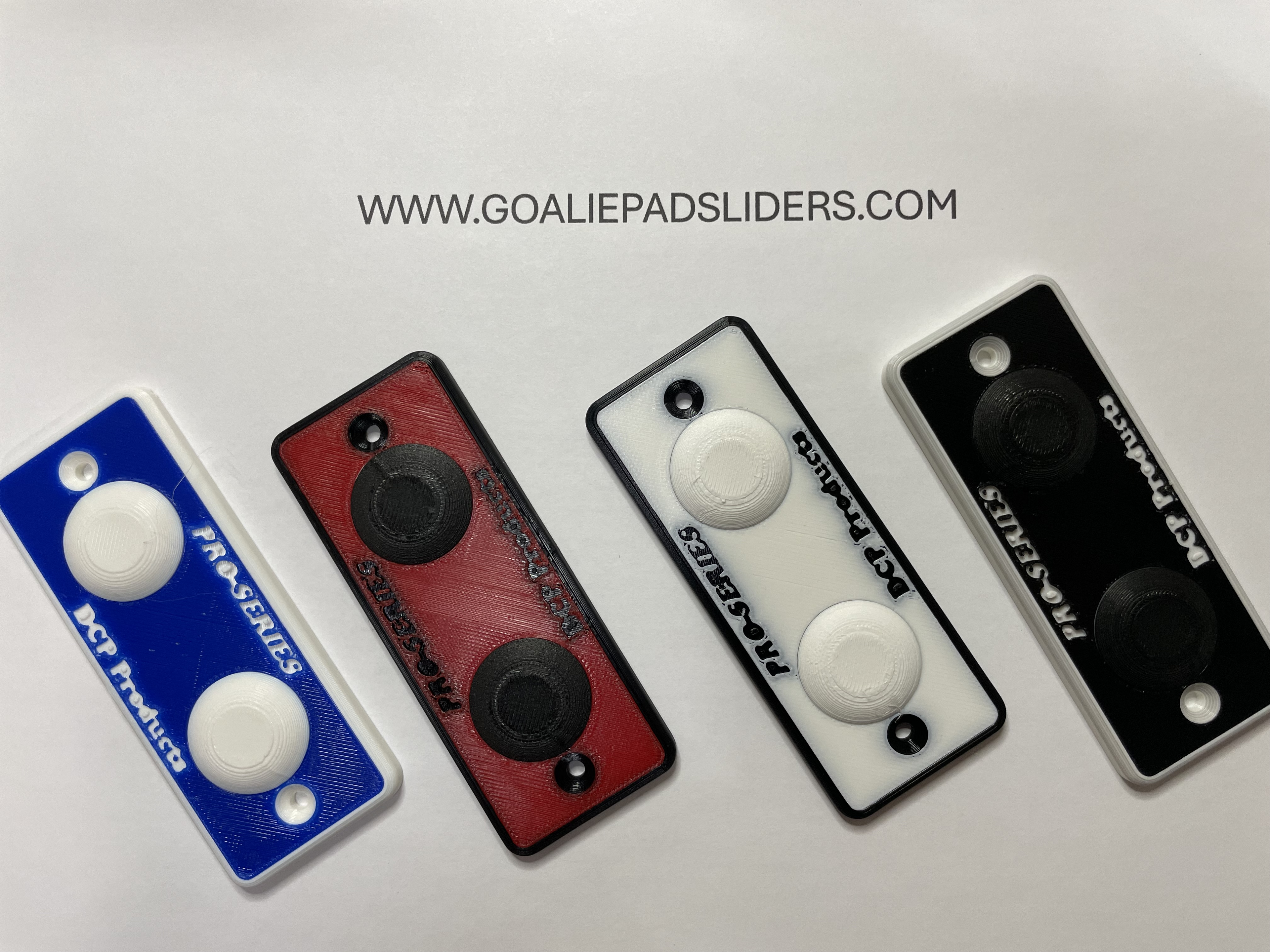 Four goalie pad sliders in different colors on a light gray background with a website address.